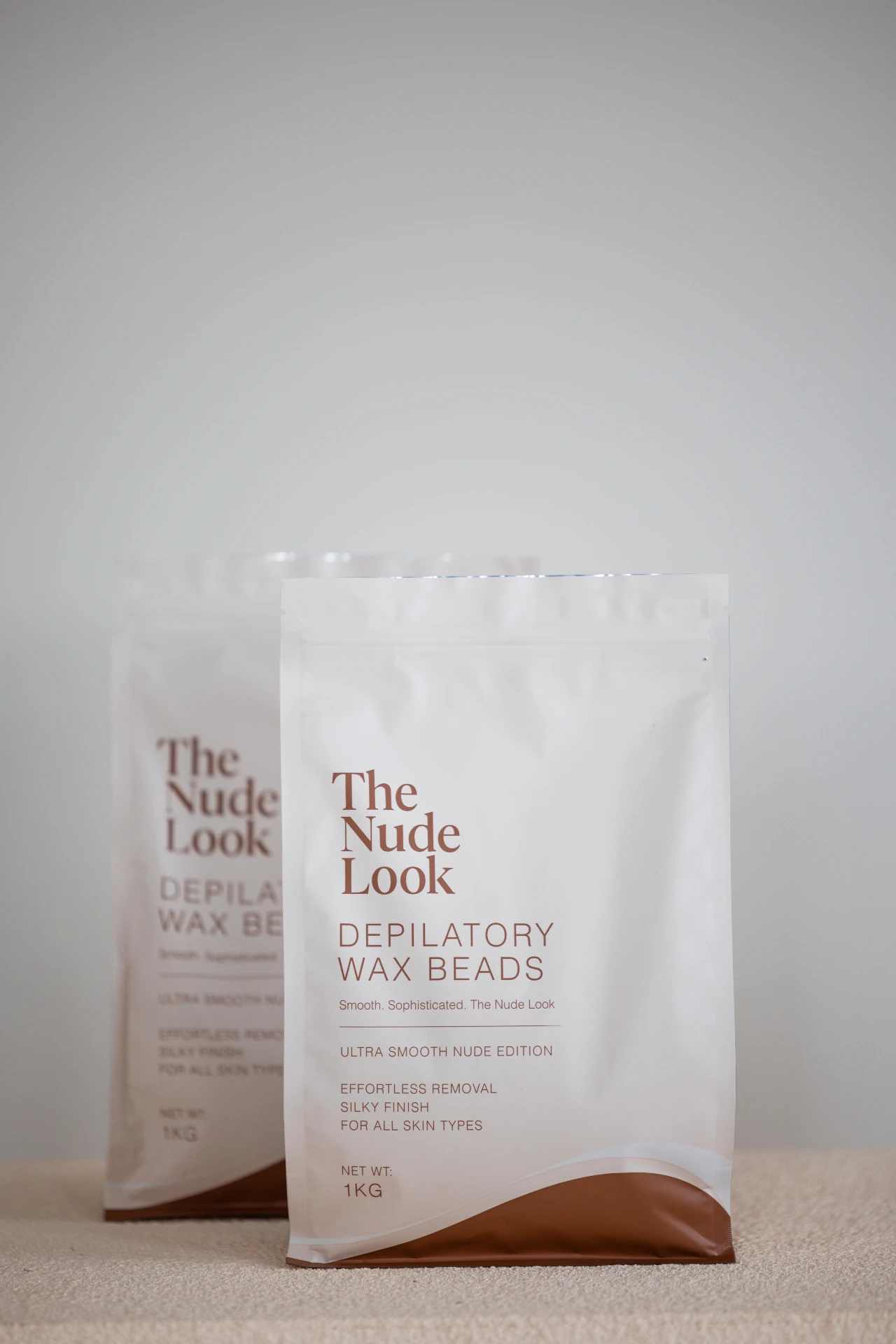 Two Nude Look Depilatory Wax Beads 1kg pouches styled side by side
